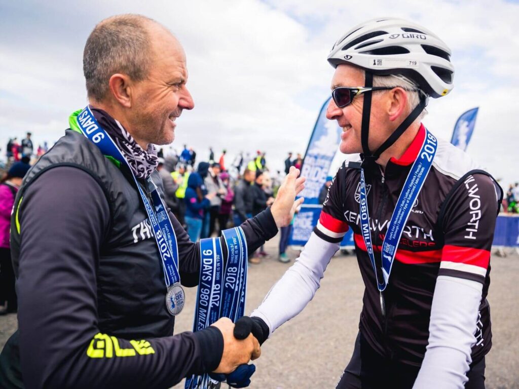 Cyclist receiving his medal at the finish line